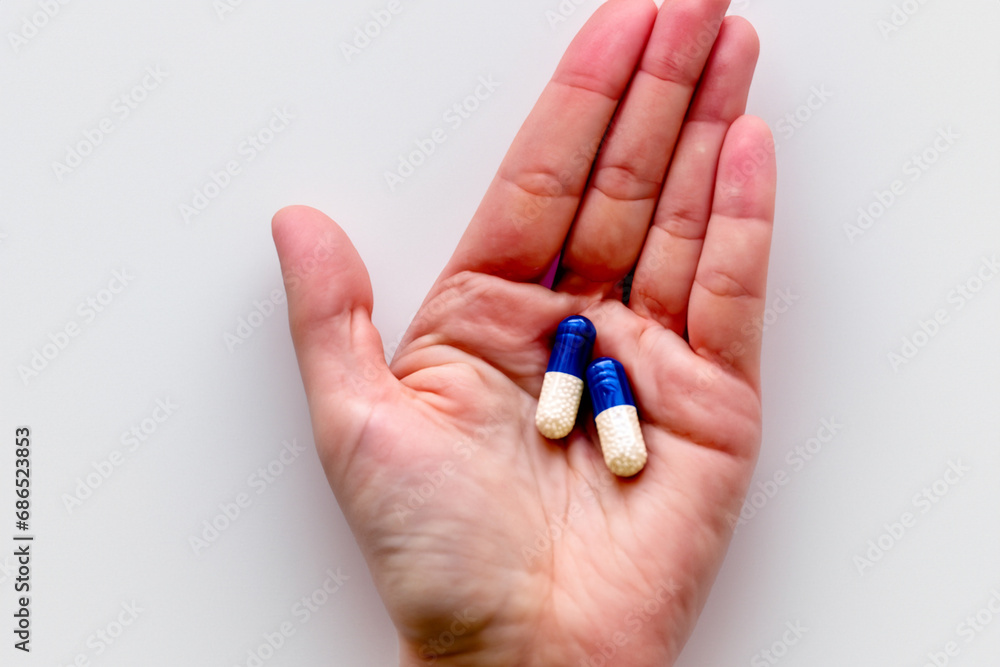 pills on the palm. medicines lie on the palm close-up. health care treatment concept