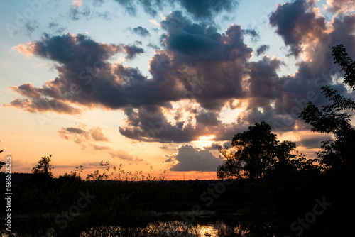 Sun at sunset hidden behind the clouds  colorful cloudy landscape