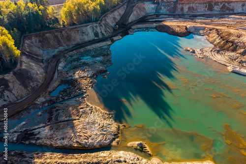 View from above of the sand quarry territory with a picturesque pond photo