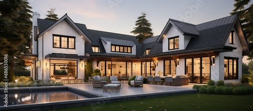 At twilight a luxurious home exterior in beautiful modern farmhouse style photo