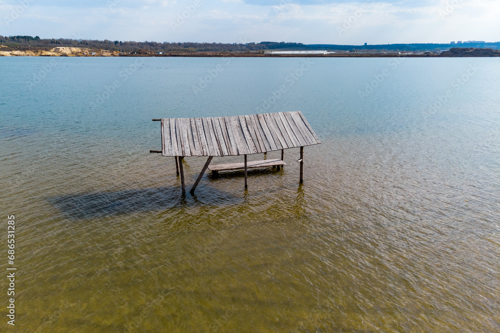 Rising water level on a lake with a flooded shore, aerial view