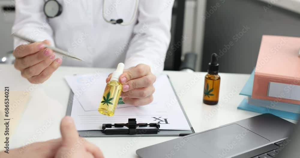 Doctor writing prescription and giving bottle of marijuana extract to patient 4k movie. Illegal drug treatment concept Doctor writing prescription and giving bottle of marijuana extract to patient 4k movie. Illegal drug treatment concept