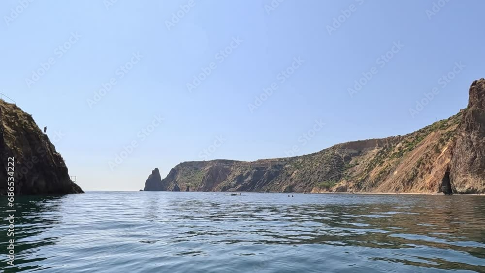 Aerial view on calm azure sea and volcanic rocky shores. Small waves on water surface. Nature summer ocean sea beach view. Nobody. Holiday, vacation and travel concept. Weather and climate change Aerial view on calm azure sea and volcanic rocky shores. Small waves on water surface. Nature summer ocean sea beach view. Nobody. Holiday, vacation and travel concept. Weather and climate change