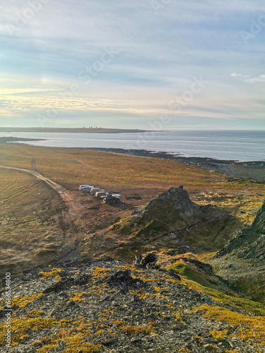 The rocky coast of the Barents Sea. Beautiful view of the rocks and the coast of the Rybachy and Sredny peninsulas, Murmansk region, Russia. The landscape is the harsh beauty of the north. photo