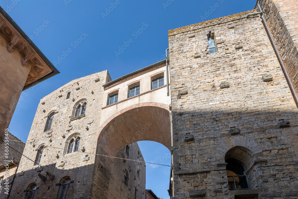 arched bridge between tower houses, Volterra, Italy