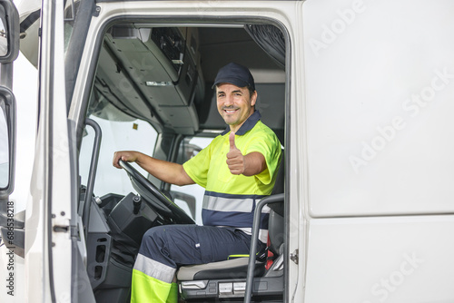Cheerful male driver showing thumb up gesture while sitting in truck