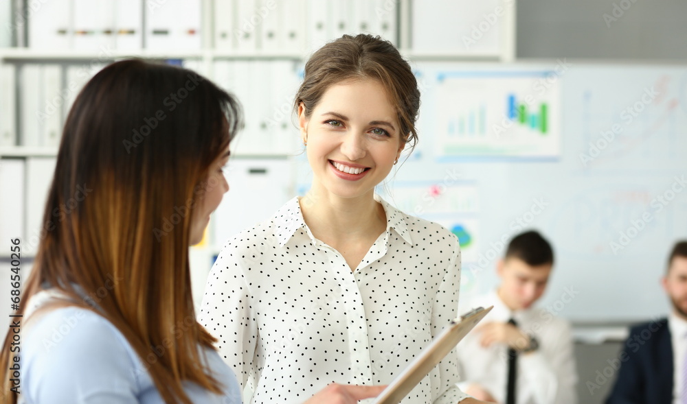 Businesswoman study documents in office. Discuss analytics graph report in team Businesswoman study documents in office. Discuss analytics graph report in team