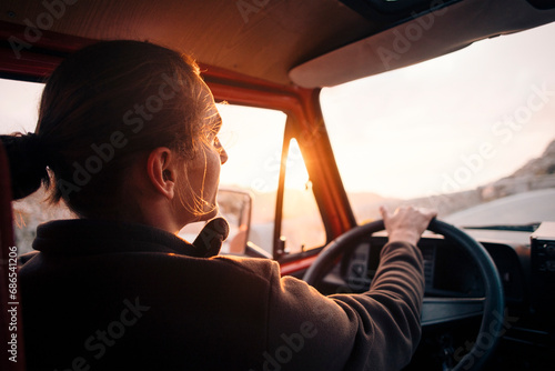 Young man driving man at sunset on vacation photo