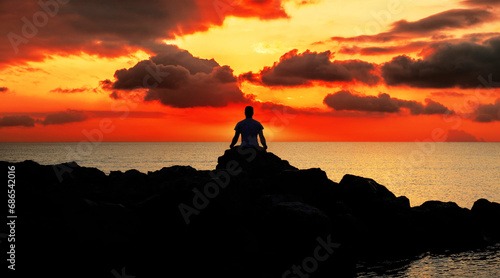 meditation on the rocks, silhouette of a person at sunset