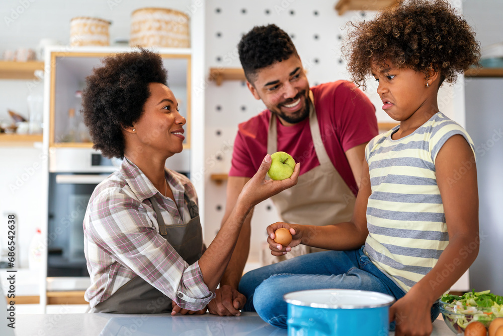 Overjoyed young african american family with kid have fun cooking at home together, Overjoyed young african american family with kid have fun cooking at home together,