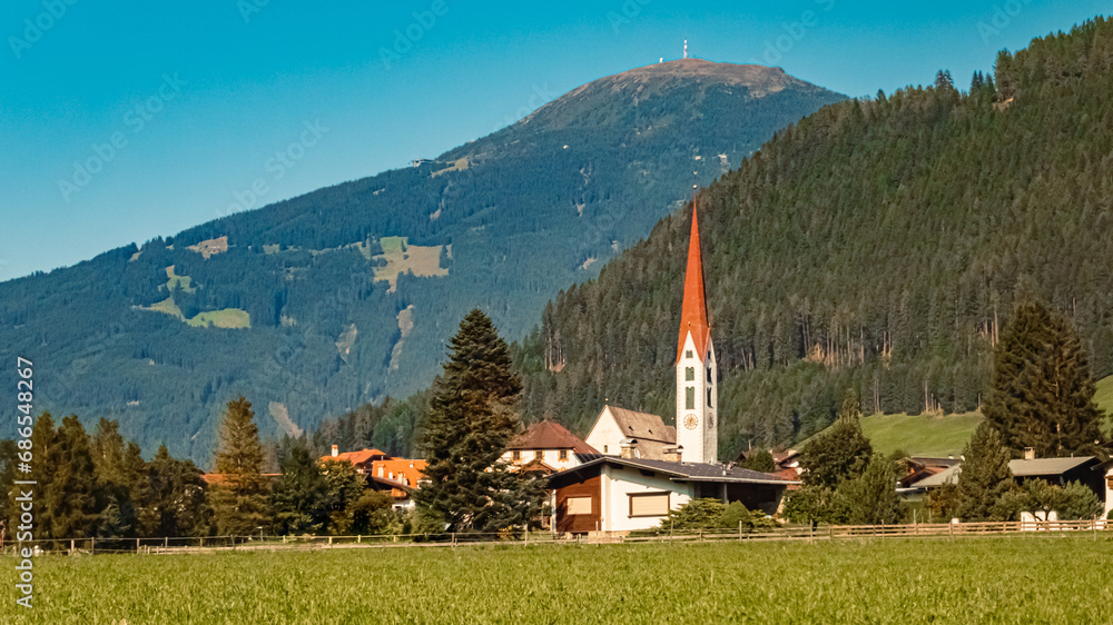Church on a sunny summer day at Mieders, Stubaital valley, Innsbruck, Austria with Mount Patscherkofel in the background