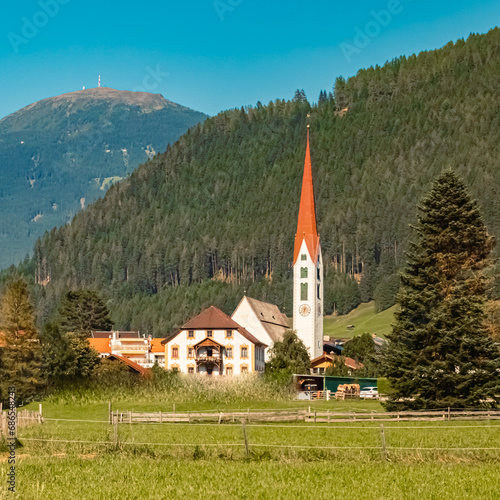 Church on a sunny summer day at Mieders, Stubaital valley, Innsbruck, Austria with Mount Patscherkofel in the background photo