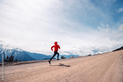 Woman trail runner cross country running at high altitude mountains