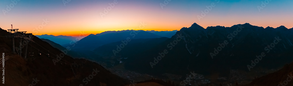 High resolution stitched alpine summer sunrise panorama at Mount Kreuzjoch, Fulpmes, Stubaital valley, Innsbruck, Austria