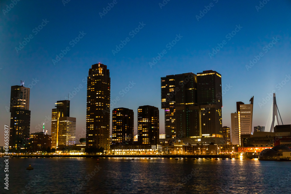 Fototapeta premium Bay of the night city of Rotterdam in the Netherlands with high-rise buildings.