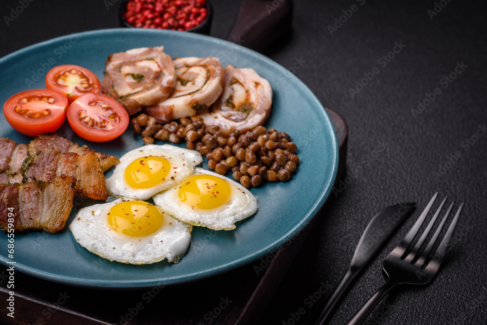 Delicious nutritious breakfast of fried quail eggs, bacon, legumes and cherry tomatoes Delicious nutritious breakfast of fried quail eggs, bacon, legumes and cherry tomatoes