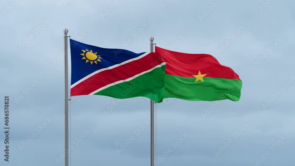 Burkina Faso flag and Namibia flag waving together on cloudy sky, endless seamless loop, two country relations concept Burkina Faso flag and Namibia flag waving together on cloudy sky, endless seamless loop, two country relations concept