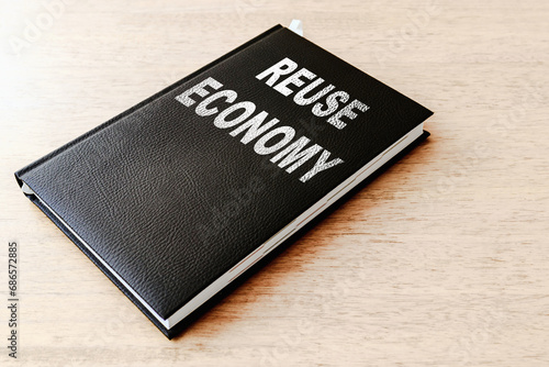 Reuse economy business black book on the office wooden table.Closeup,selective focus.