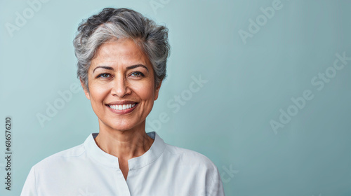 Confident mature woman with gray hair smiling. photo