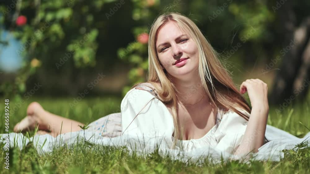 Blonde girl lying in a clearing in the garden. Blonde girl lying in a clearing in the garden.