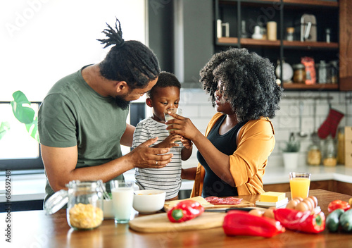 child family kitchen boy son mother father drink breakfast milk healthy drinking food eating glass home black african american father man together love cute childhood