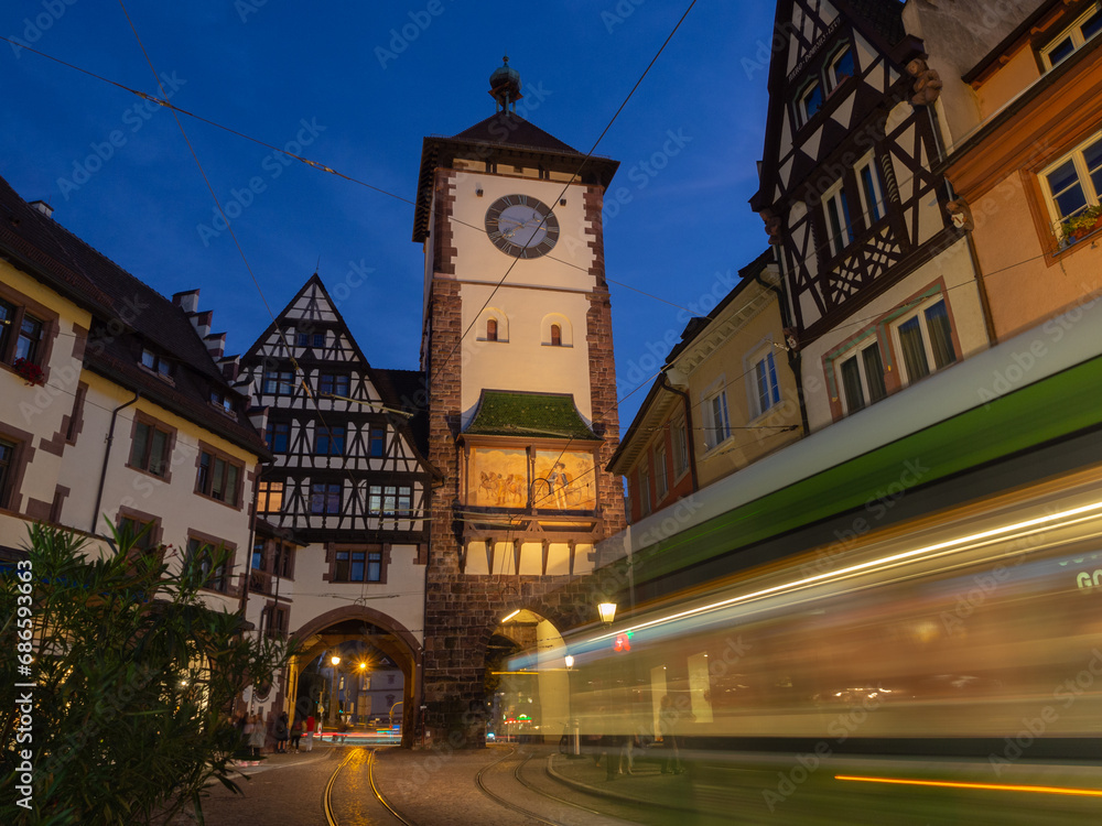 Schwabentor, Freiburg im Breisgau, Germany and tram leaving a light trail at night