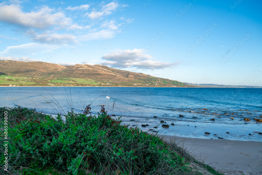 Sandy Beach with Clear Blue Water and Mountain View
