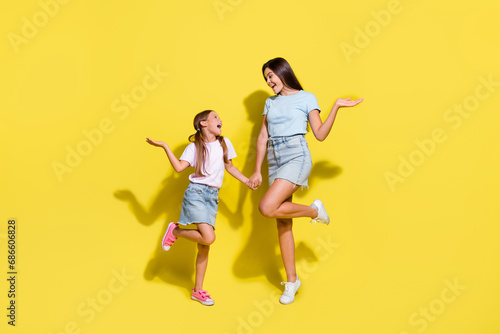 Photo of two girls older younger sisters enjoy free time together isolated over bright color background