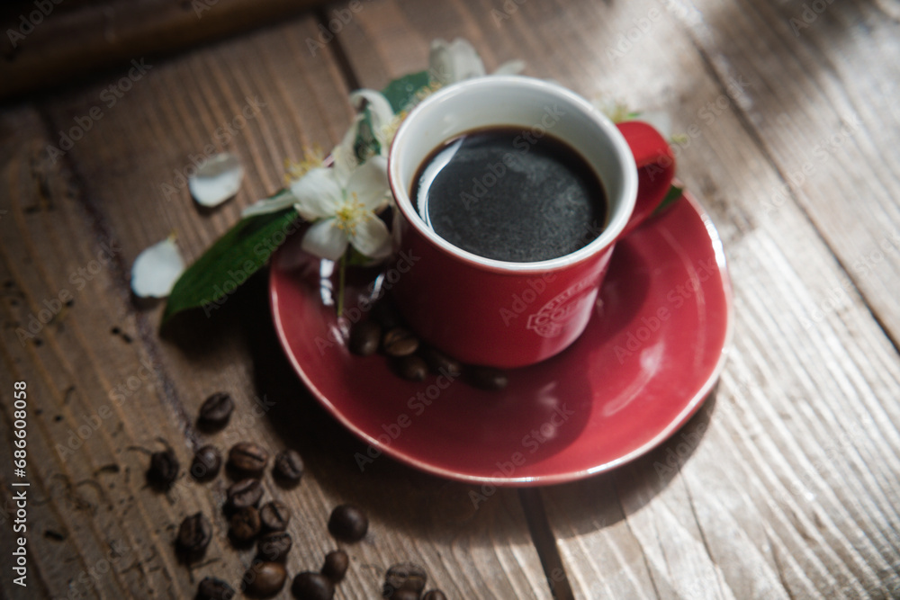 Obraz premium tazza di caffe con fiore e chicco di caffè
