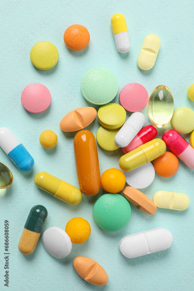 Many different pills on light blue background, flat lay Many different pills on light blue background, flat lay