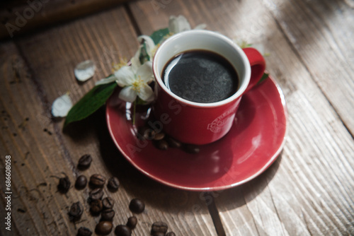 tazza di caffe con fiore e chicco di caffè photo
