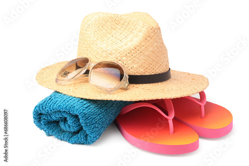 Straw hat, towel, sunglasses and flip flops isolated on white. Beach objects