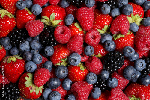 Assortment of fresh ripe berries as background, top view