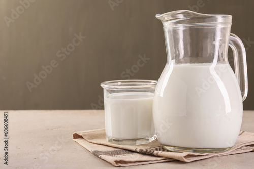 Glassware with tasty milk on light table, space for text