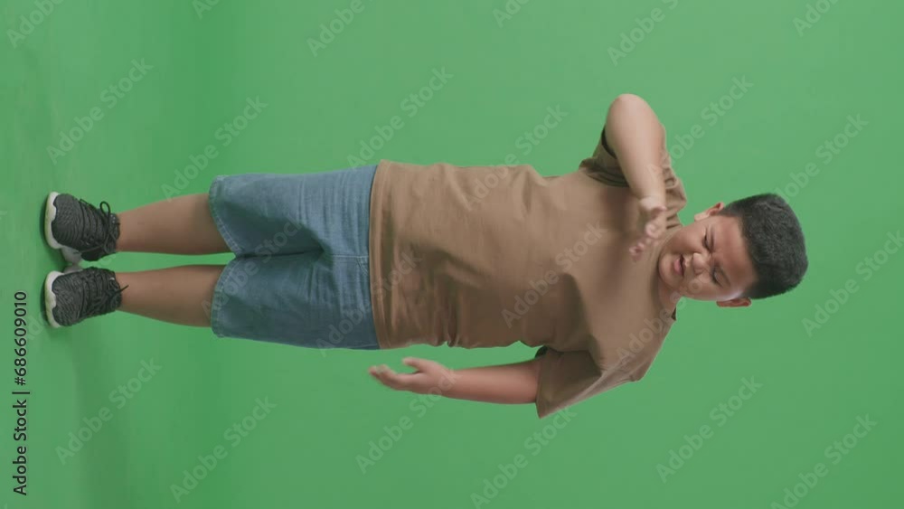 Full Body Of Tired Asian Boy While Standing In Front Of Green Screen
Full Body Of Tired Asian Boy While Standing In Front Of Green Screen