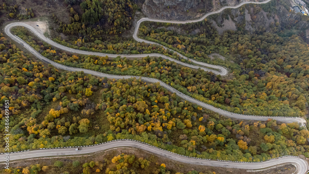 the road running serpentines in the autumn mountains