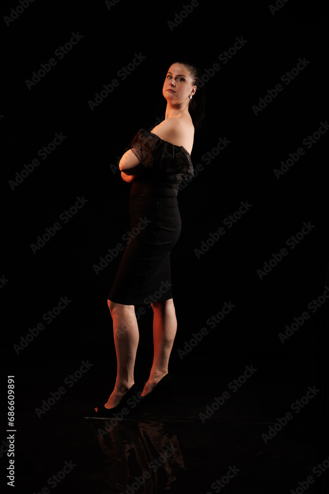 brunette woman posing in black studio brunette woman posing in black studio