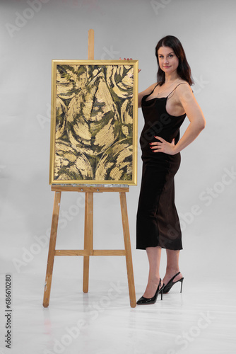 female artist paints a picture in the studio photo