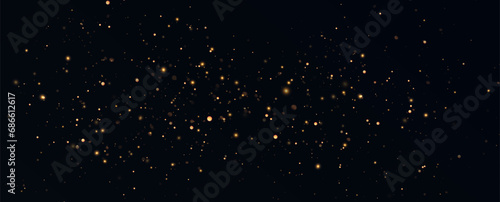 Golden sequins glow with many lights. Glittering dust. Luxurious background of golden particles.  © blagorodez
