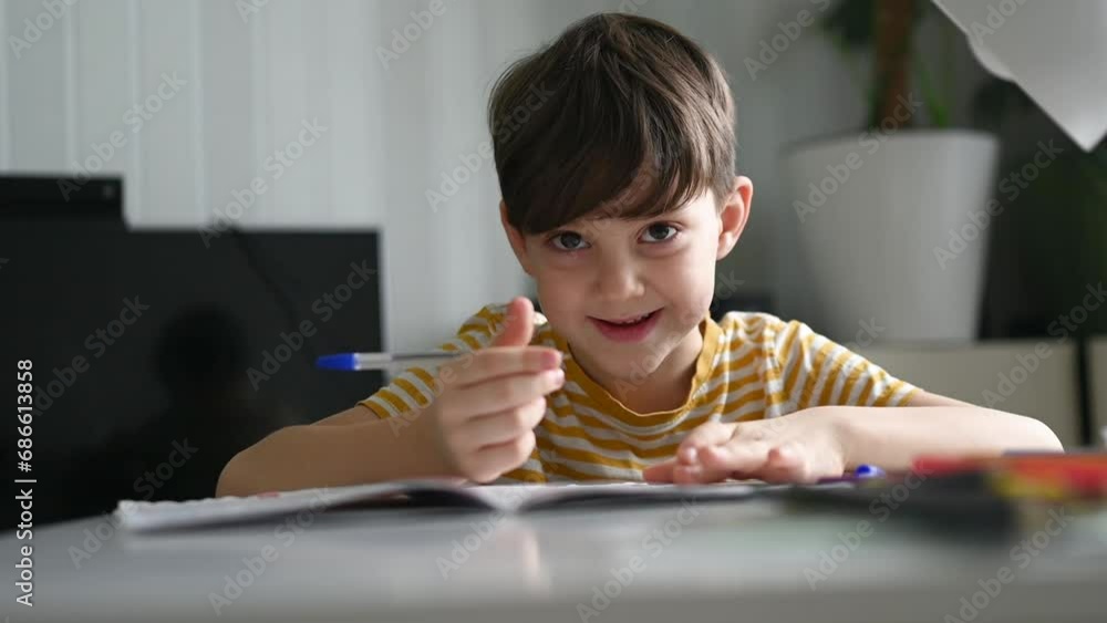 A 6-7-year-old boy is doing homework at home. A child learns to write A 6-7-year-old boy is doing homework at home. A child learns to write