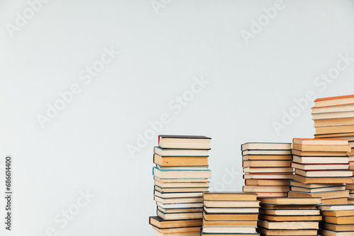 Lots of stacks of educational books on white school university library background