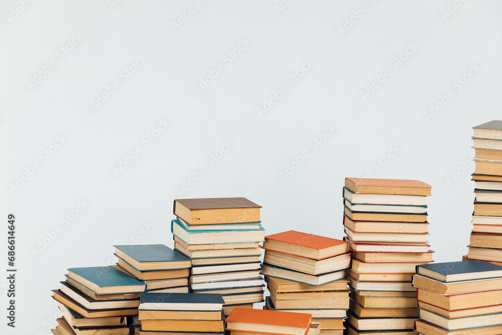 Lots of stacks of educational books on white school university library background Lots of stacks of educational books on white school university library background