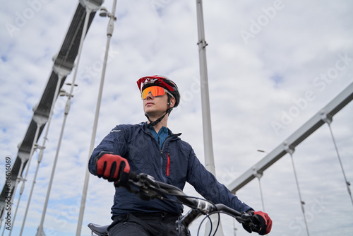 Portrait of a cyclist man against the background of the city.