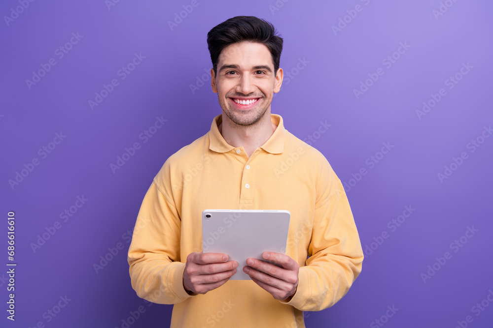 Photo of good mood charming guy wear yellow polo chatting instagram twitter telegram facebook isolated violet color background Photo of good mood charming guy wear yellow polo chatting instagram twitter telegram facebook isolated violet color background