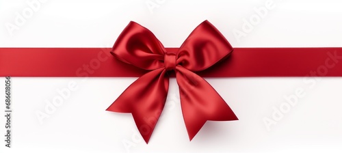 Red ribbon bow on white background for birthday or christmas banners with customizable text space.