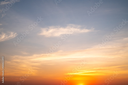 Beautiful of luxury soft gradient orange gold clouds and sunlight on the blue sky perfect for the background, take in everning,Twilight