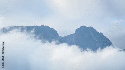 Polish Tatra Mountains  Giewont peak - sleeping knight  foggy morning  thick fog obscures the mountain peaks hidden in the shadow.