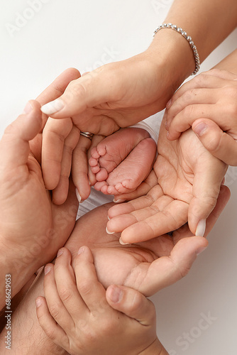 Children's foot in the hands of mother, father, parents. Feet of a tiny newborn close up. Little baby legs. Mom and her child. Happy family concept. Beautiful concept image of motherhood stock photo. 