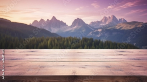 Wooden table top with a blurred mountain landscape at dusk purple sunset in forest woodland natural background landscape.