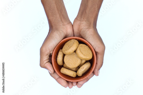 Holding some Indian sweet peda or Pera in a hand top view 